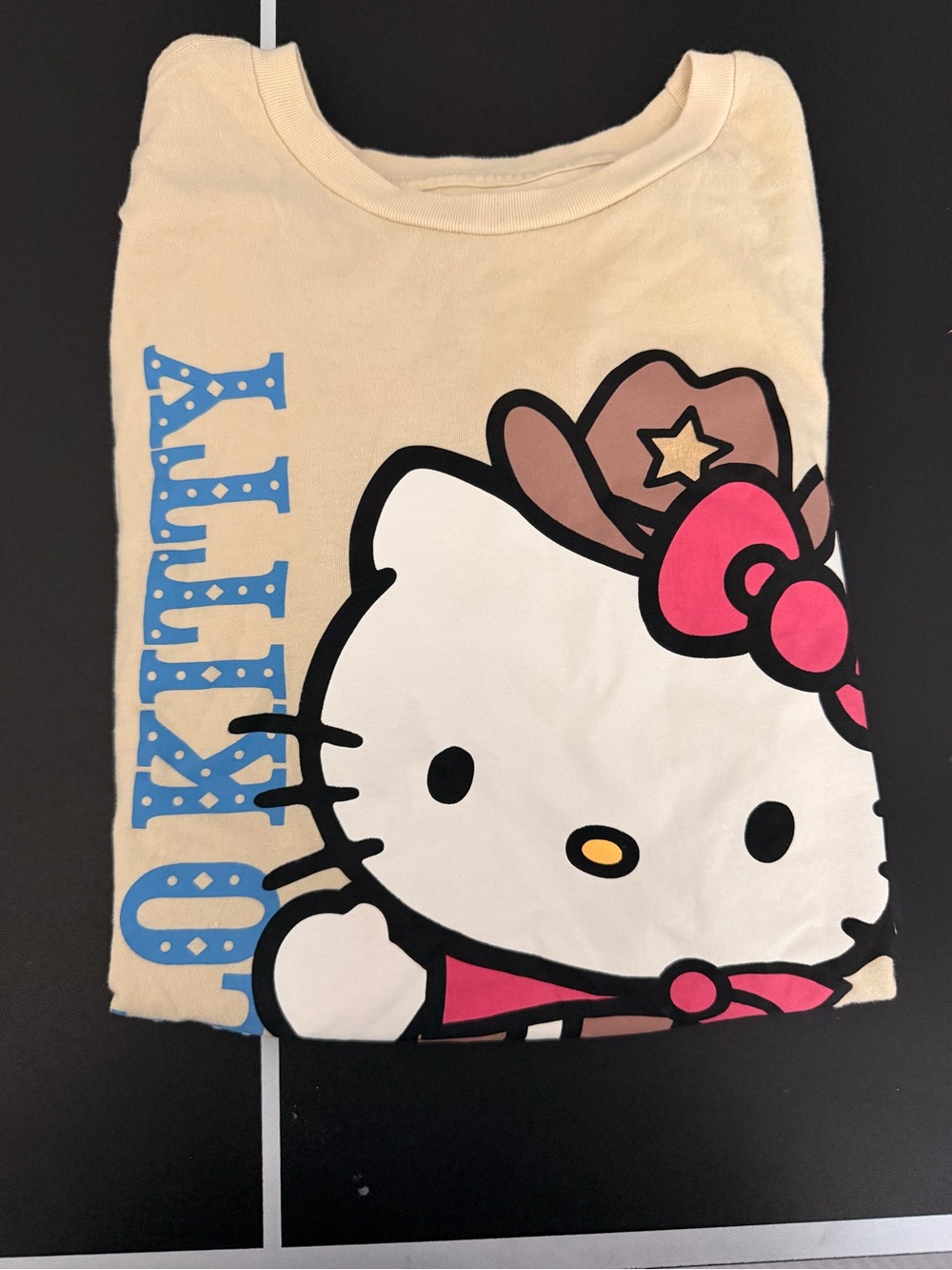 Hello Kitty Cream Short Sleeve Tee with Pink Bow and Blue Logo